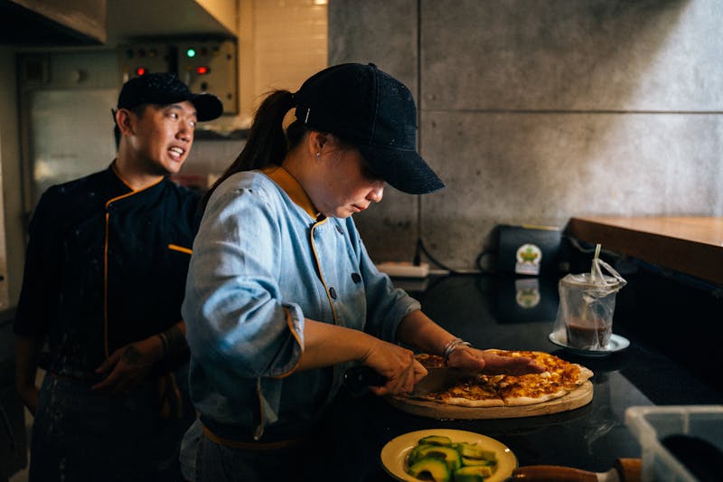 Mod Pizza team preparing fresh pizzas in the kitchen